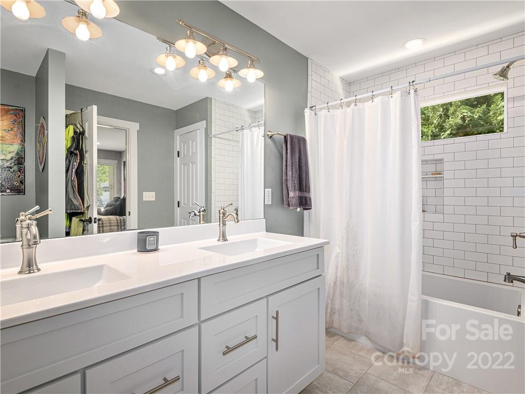 1 Inglewood Road Asheville, NC 28804 - Photo 27 of 40 a bathroom with a double vanity sink mirror and shower