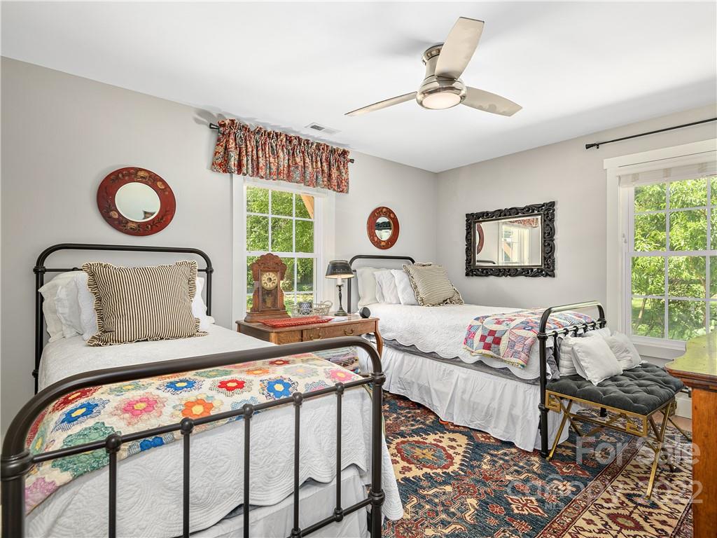 1 Inglewood Road Asheville, NC 28804 - Photo 30 of 40 a bedroom with a bed and a window