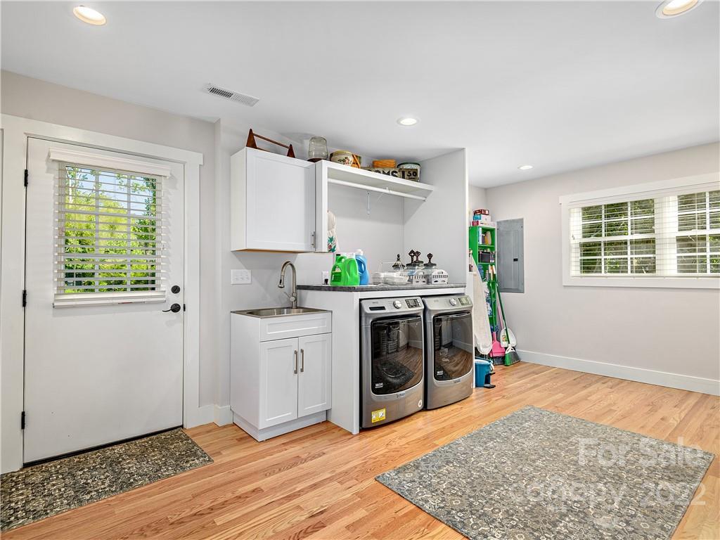 1 Inglewood Road Asheville, NC 28804 - Photo 33 of 40 a kitchen with a stove a sink and a window