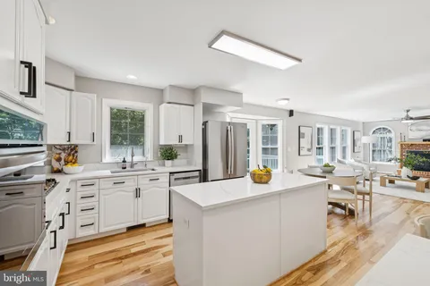 a open kitchen with stainless steel appliances kitchen island granite countertop a sink and cabinets