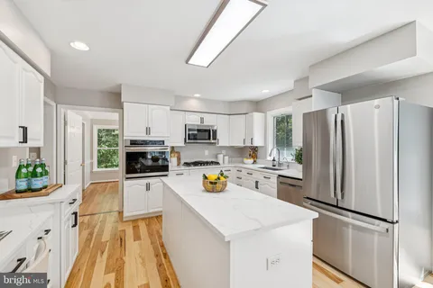 a kitchen view with stainless steel appliances a refrigerator sink and stove