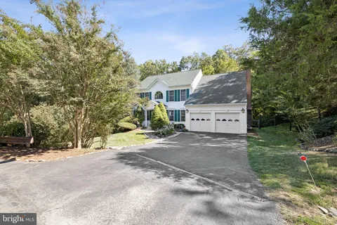 a view of house with backyard and a tree