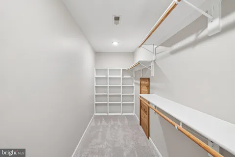 a view of a big room with wooden cabinets and windows