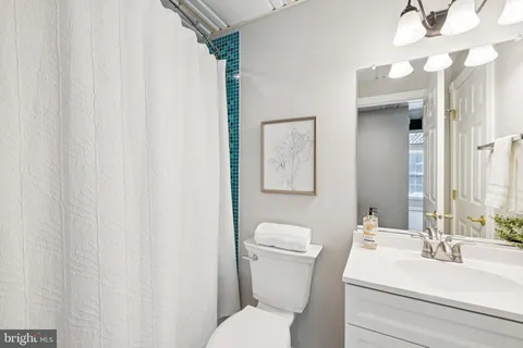 a white toilet sitting next to a bathroom sink