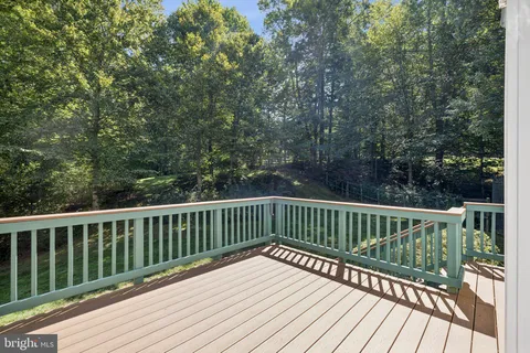 a view of backyard with deck and wooden floor