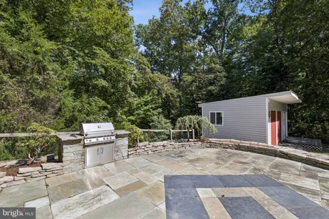 a backyard of a house with table and chairs