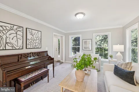 a living room with furniture and flowers