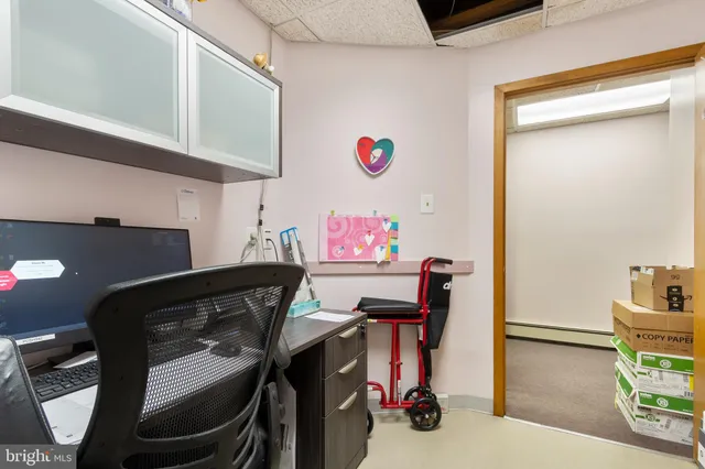 a view of a workspace with furniture and a dresser