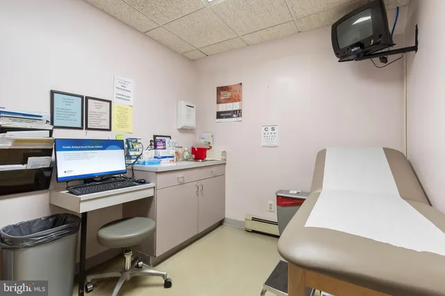 a view of a workspace with furniture and a window