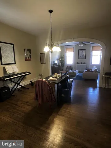 a room with wooden floor and ceiling fan