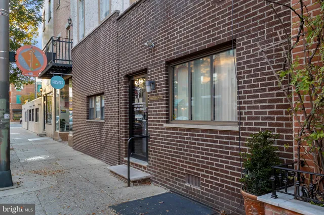 a view of brick house with a large windows