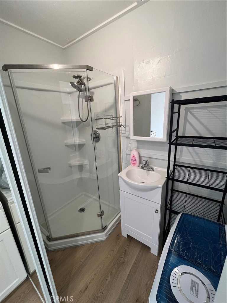 24407 1/2 Alliene Avenue Lomita, CA 90717 - Photo 2 of 6 a bathroom with a sink a mirror and a shower