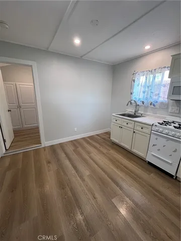 a room with hard wood floors and a sink