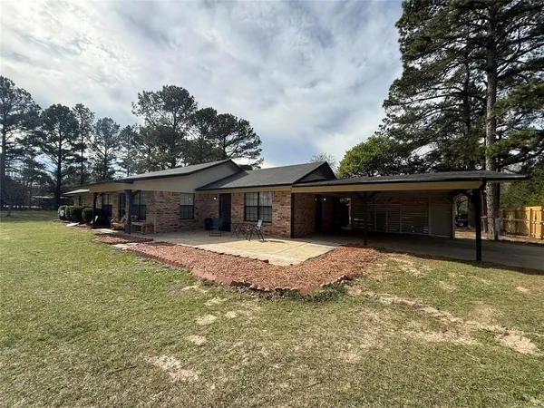 a front view of house with a garden