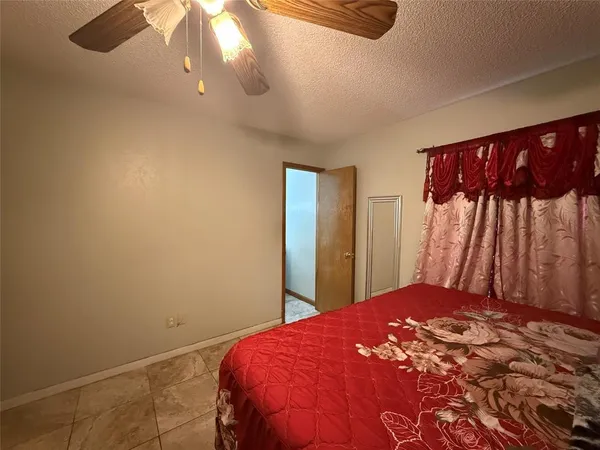 a living room with furniture and a ceiling fan