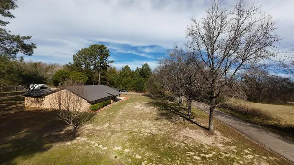 a view of a house with yard and sitting area