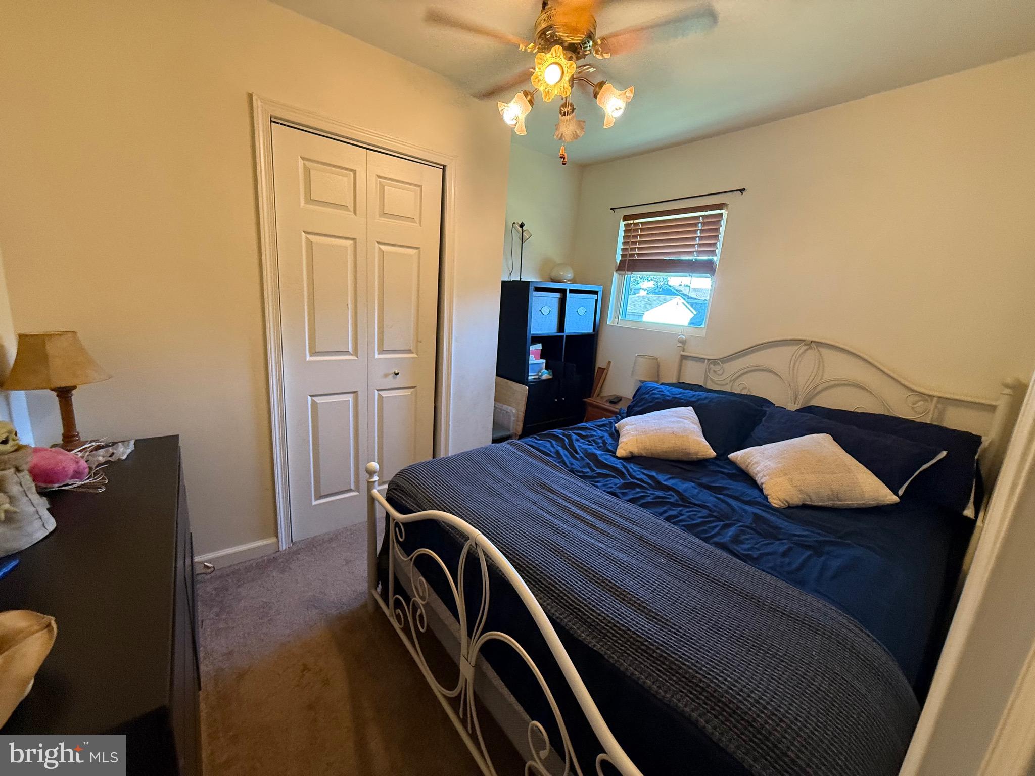 243 C Street Carneys Point, NJ 08069 - Photo 17 of 21 a bedroom with a bed and chandelier