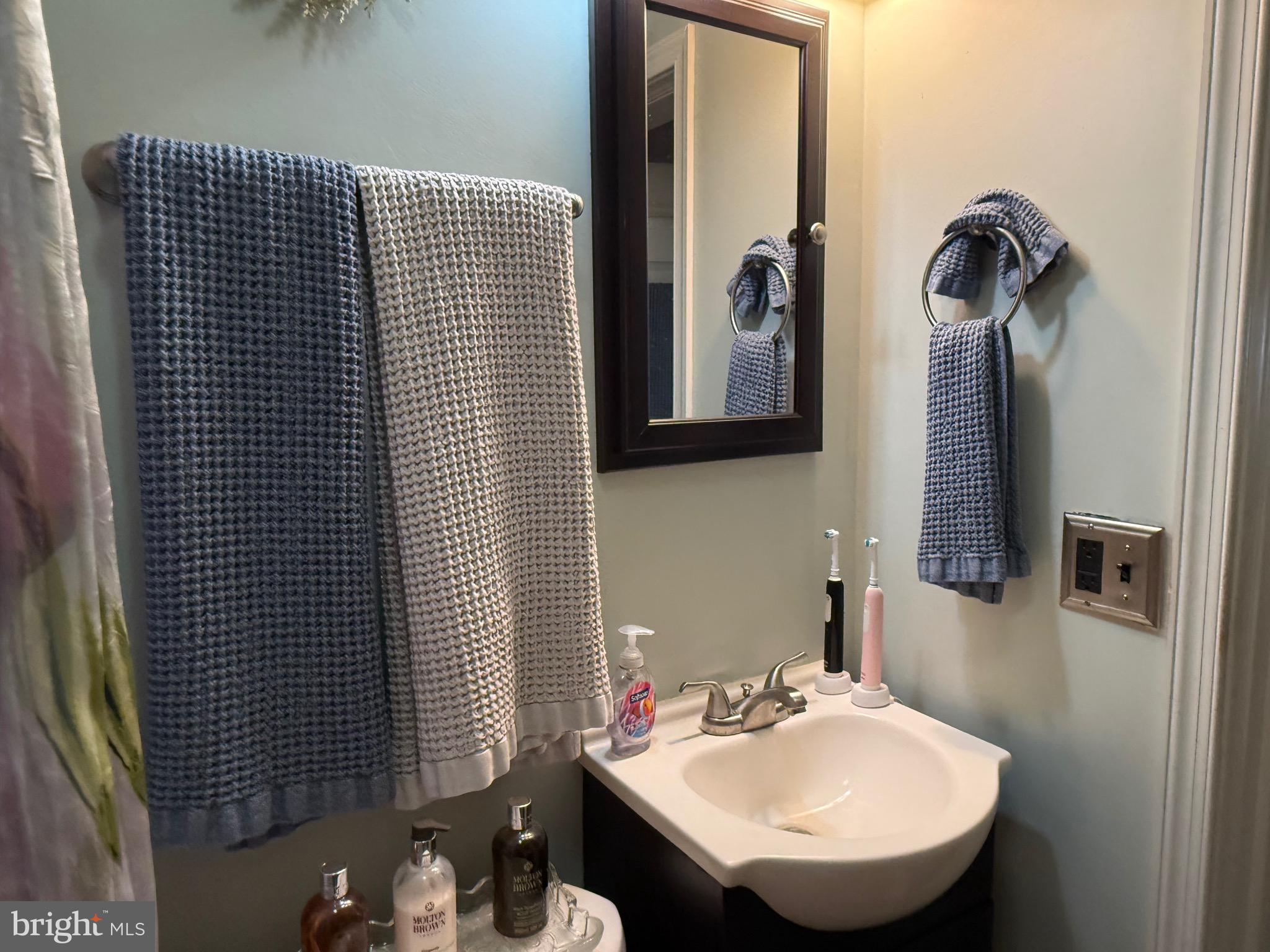 243 C Street Carneys Point, NJ 08069 - Photo 21 of 21 a bathroom with a sink and a mirror