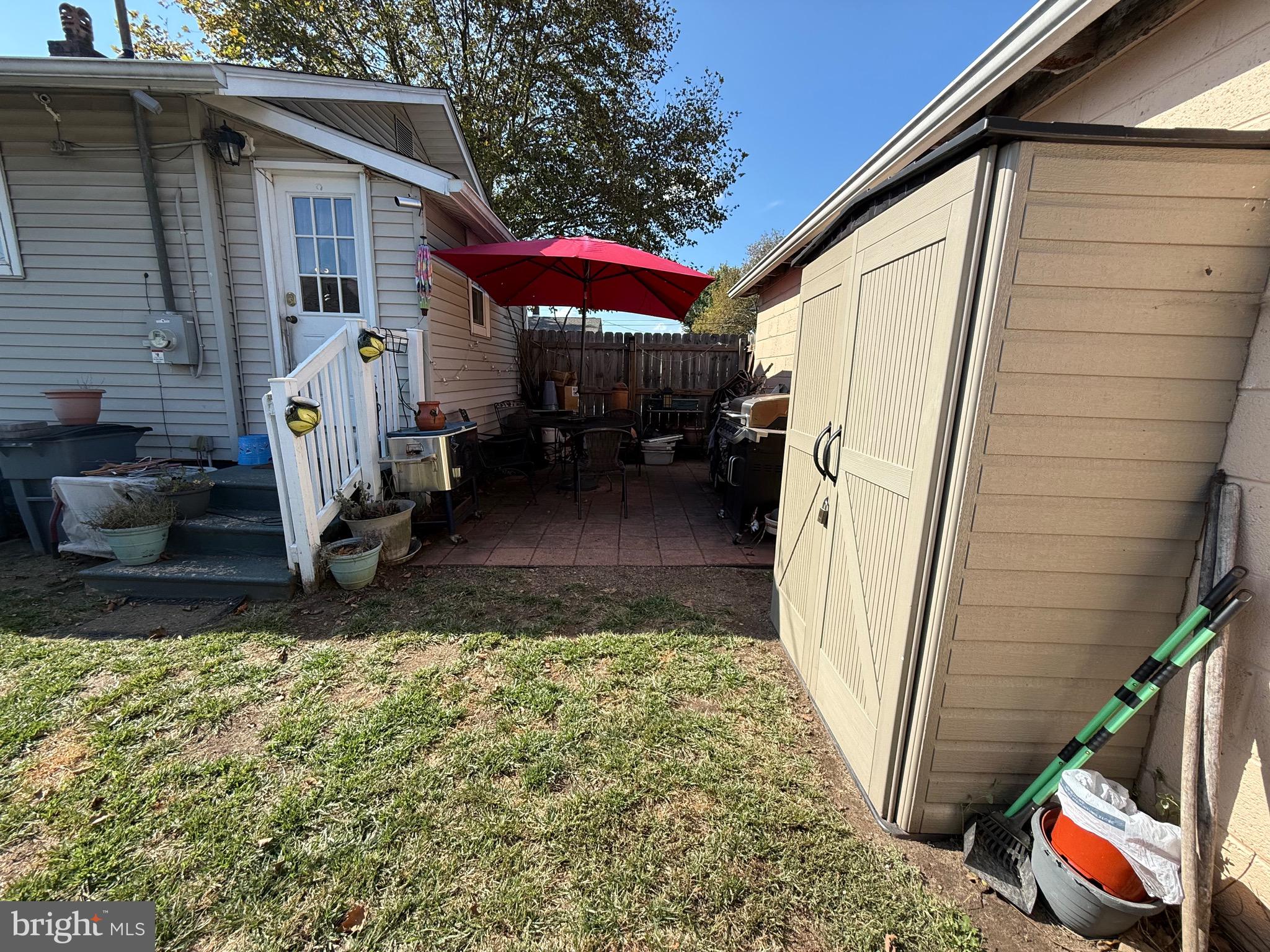 243 C Street Carneys Point, NJ 08069 - Photo 8 of 21 a view of a house with a small yard and wooden fence
