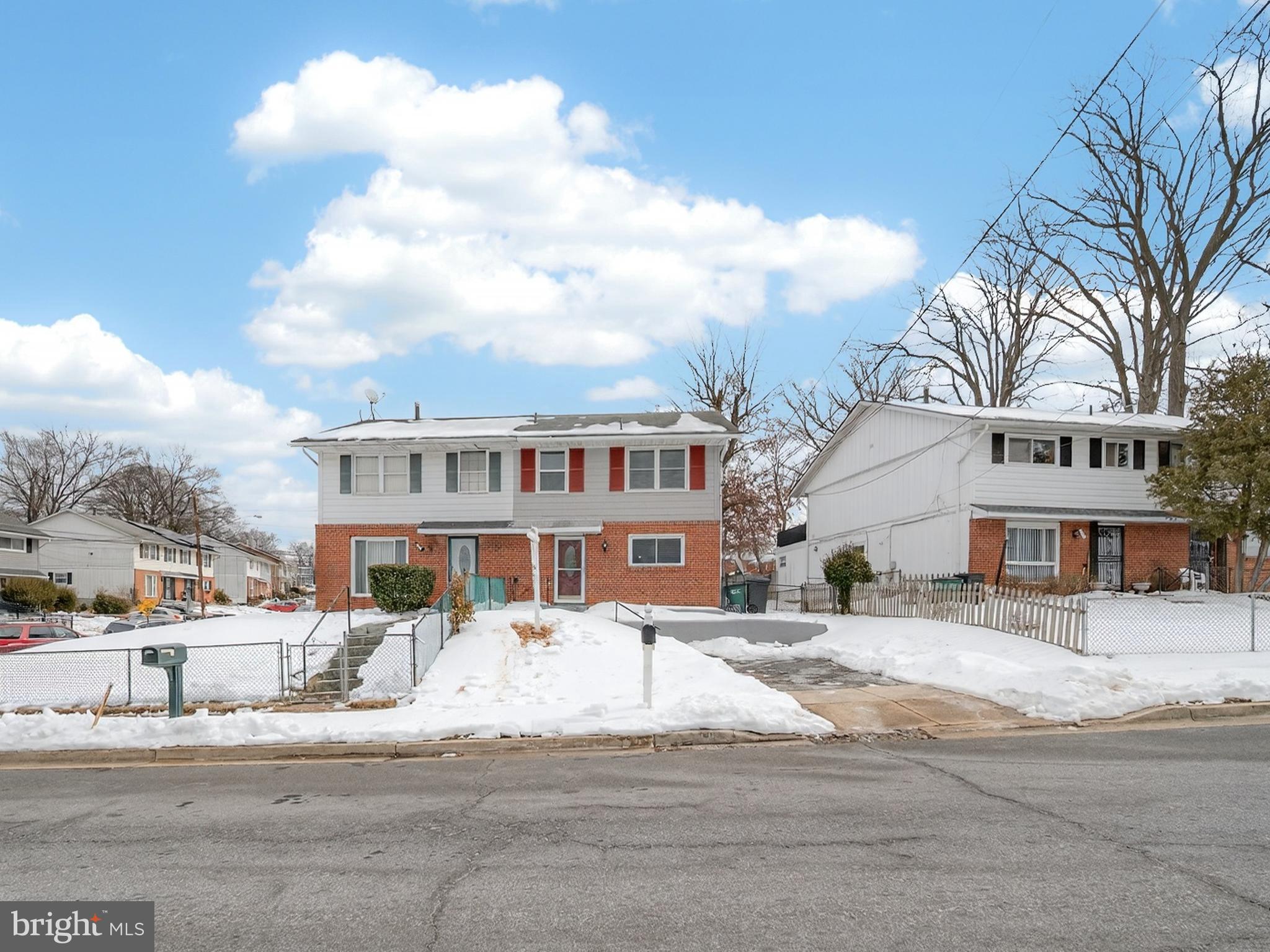 a front view of a building with lot of cars and trees