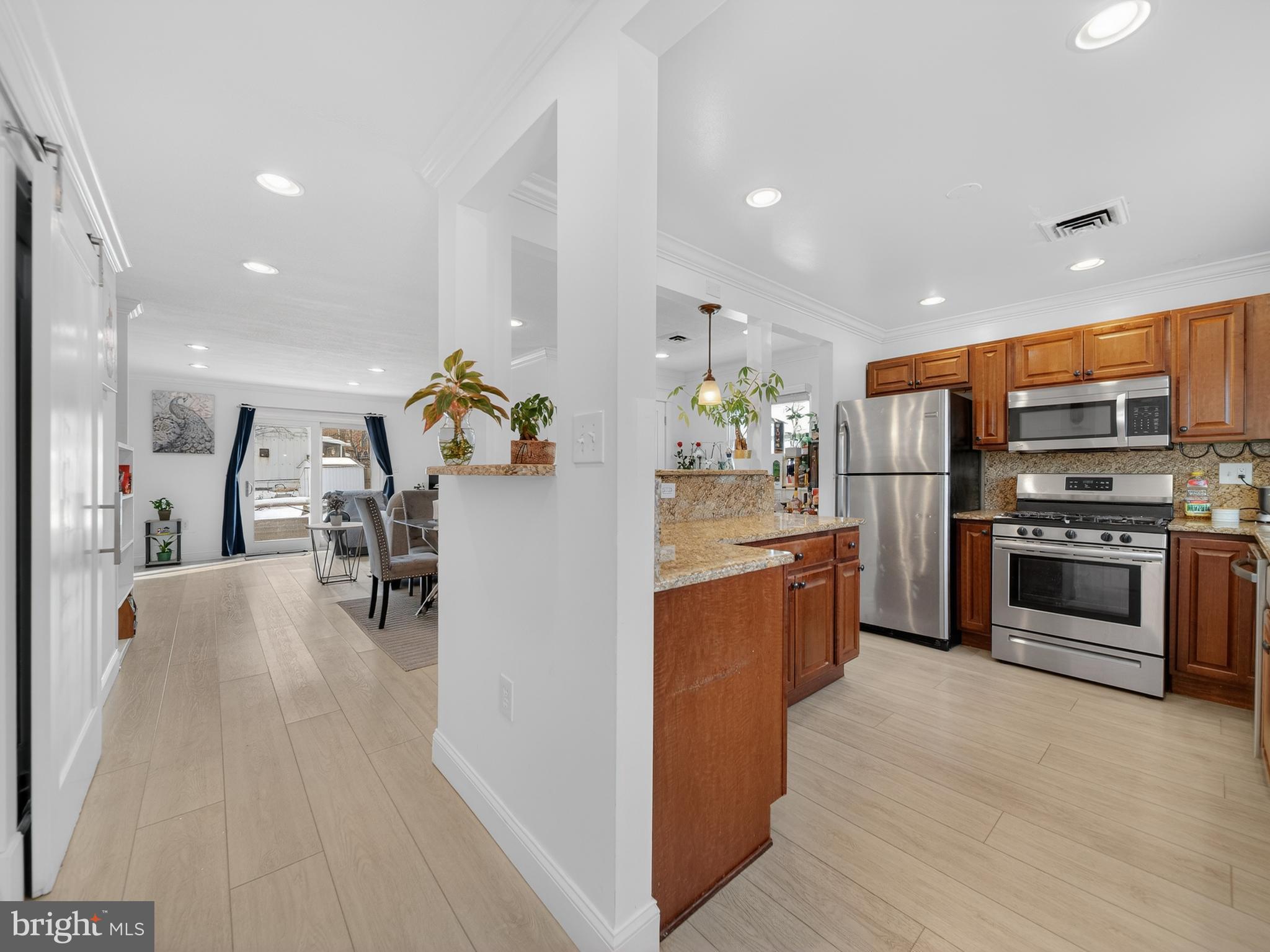 609 Cedarleaf Avenue Capitol Heights, MD 20743 - Photo 2 of 42 a kitchen with stainless steel appliances kitchen island granite countertop a stove and a refrigerator