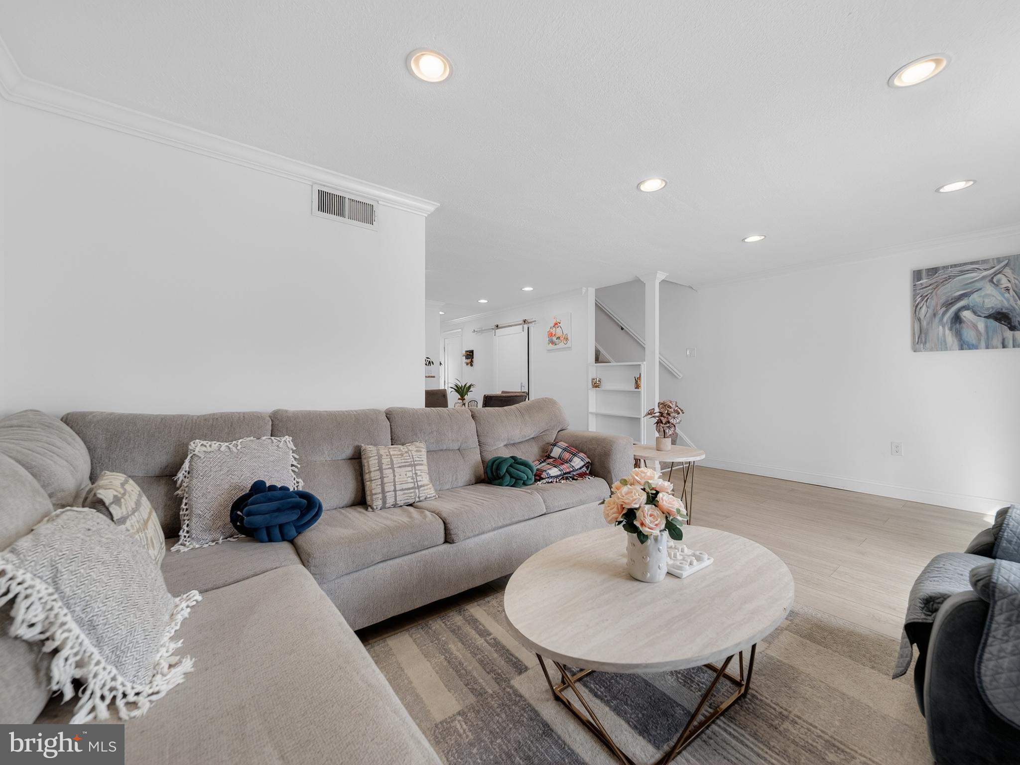 609 Cedarleaf Avenue Capitol Heights, MD 20743 - Photo 21 of 42 a living room with furniture a rug and a chandelier