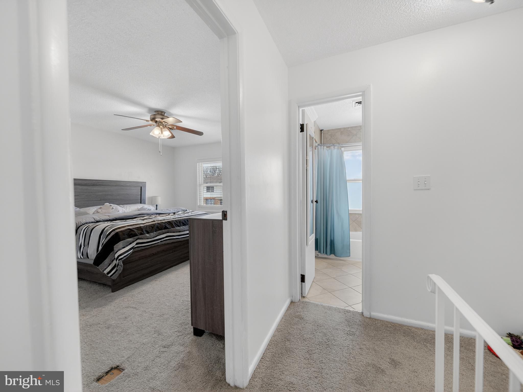 609 Cedarleaf Avenue Capitol Heights, MD 20743 - Photo 25 of 42 a bedroom with a bed and a chandelier