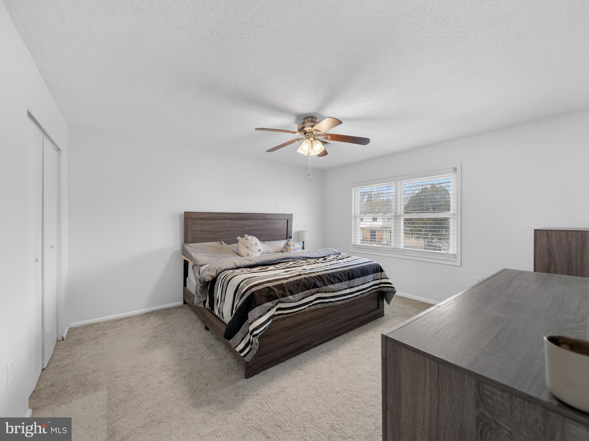 609 Cedarleaf Avenue Capitol Heights, MD 20743 - Photo 28 of 42 a bedroom with a bed and a chandelier