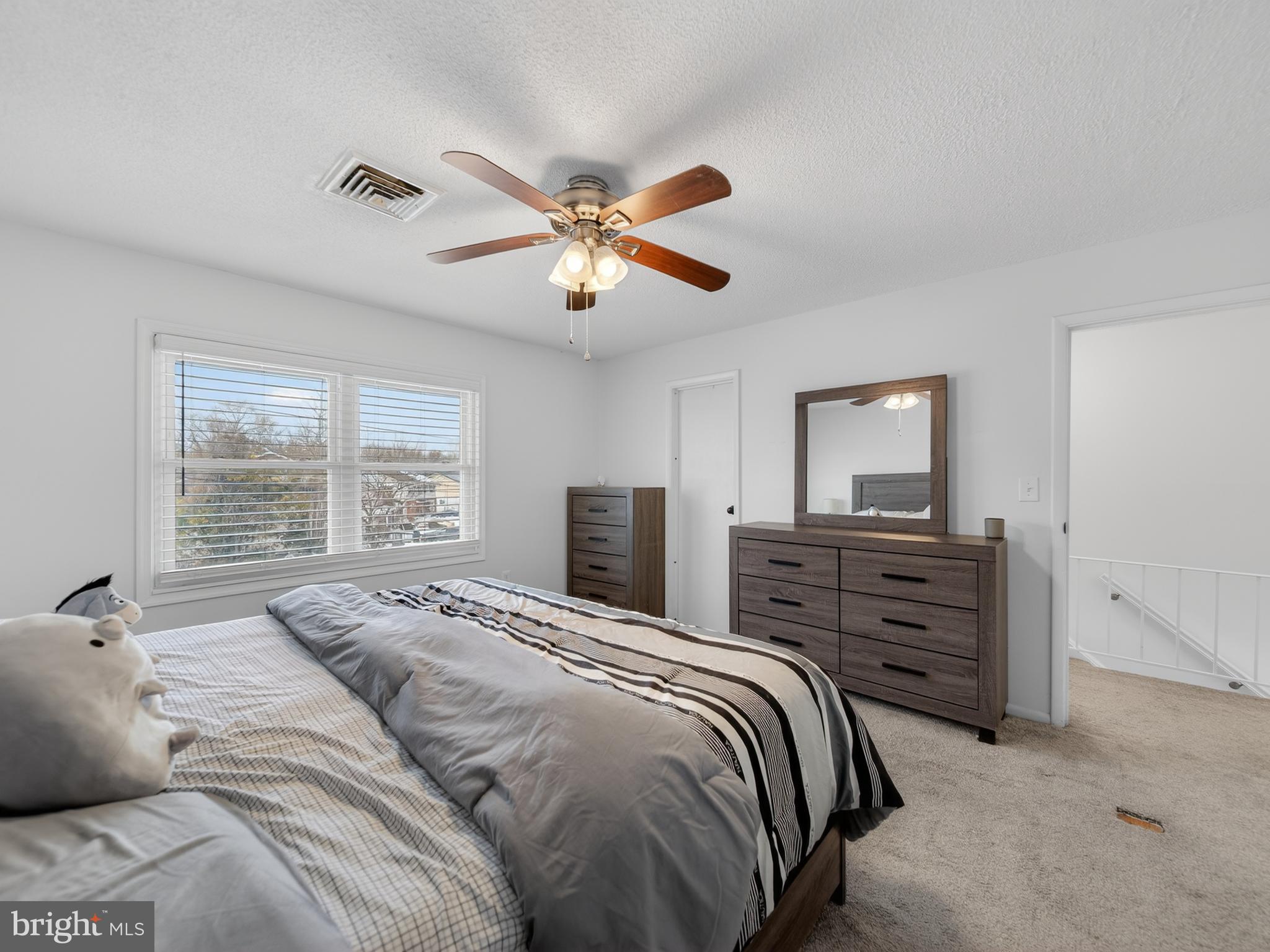 609 Cedarleaf Avenue Capitol Heights, MD 20743 - Photo 31 of 42 a bedroom with a bed and a chandelier