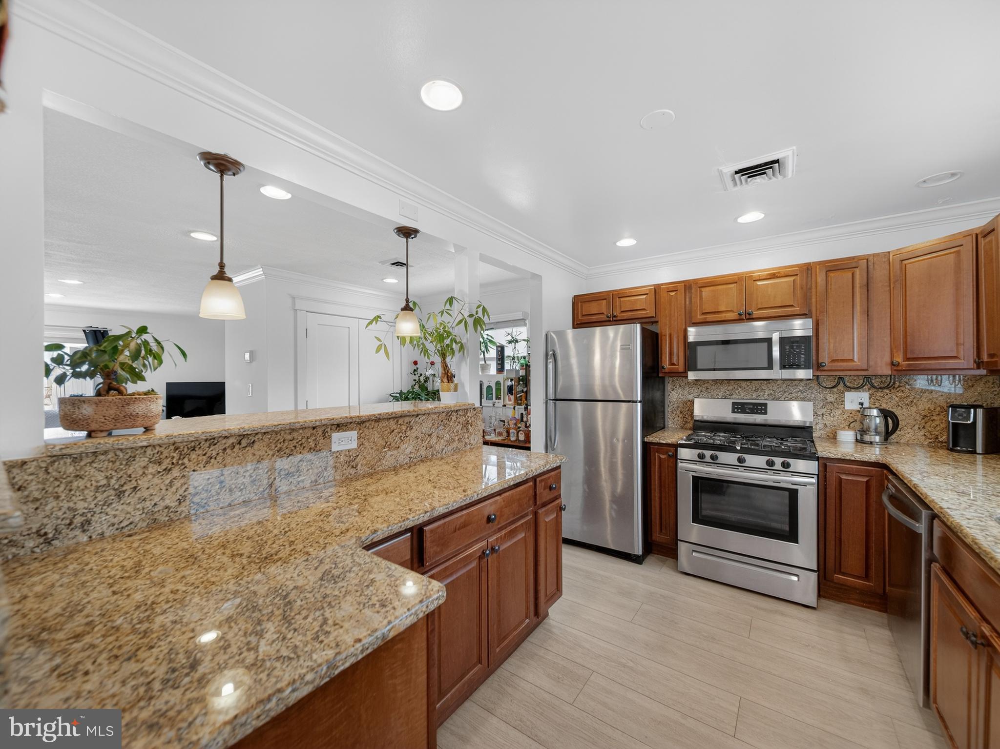 609 Cedarleaf Avenue Capitol Heights, MD 20743 - Photo 8 of 42 a kitchen with stainless steel appliances granite countertop wooden cabinets and a granite counter tops