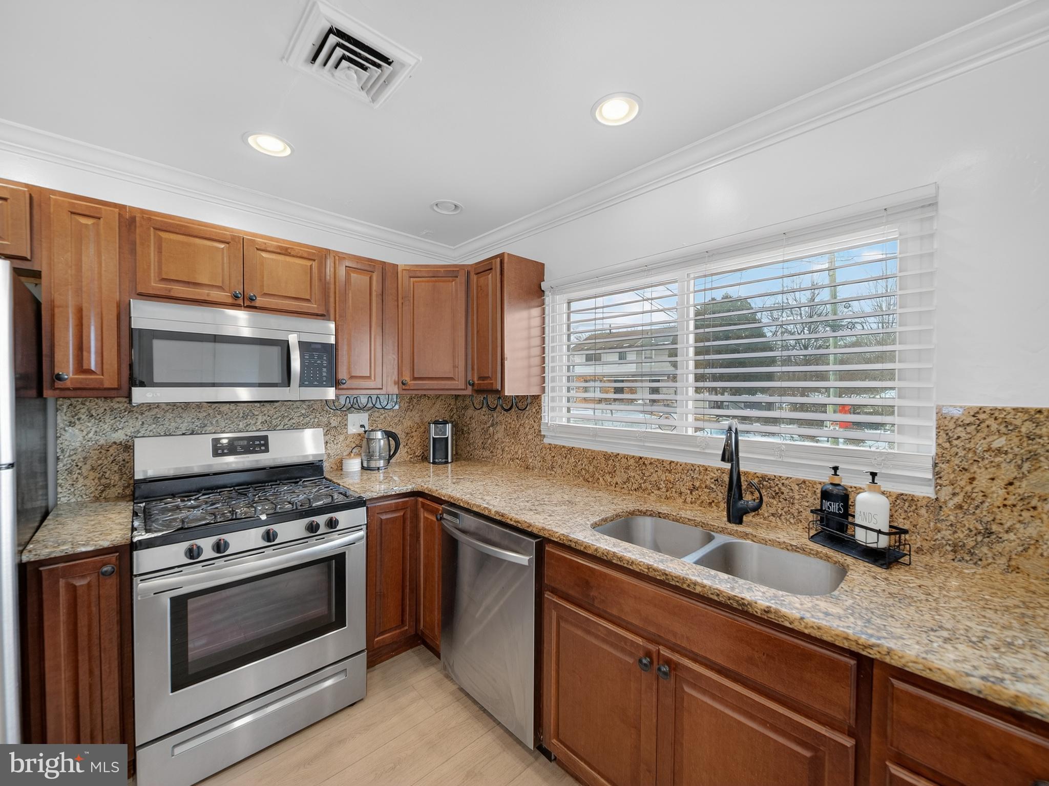 609 Cedarleaf Avenue Capitol Heights, MD 20743 - Photo 9 of 42 a kitchen with stainless steel appliances granite countertop a sink a stove and cabinets