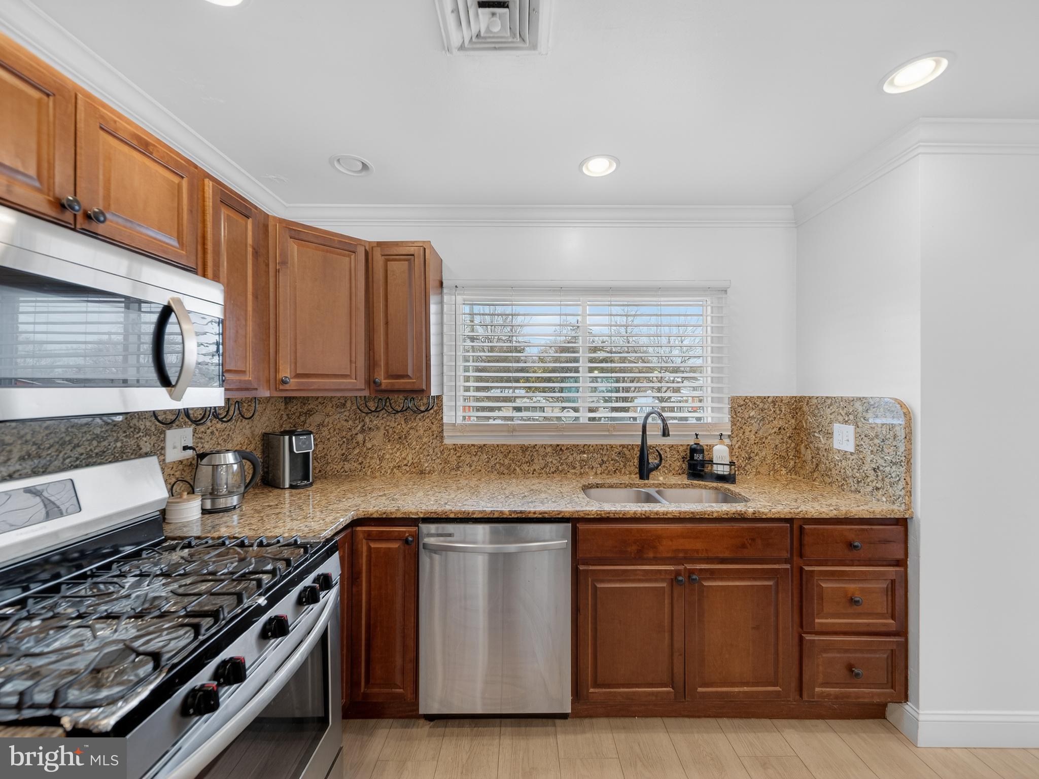 609 Cedarleaf Avenue Capitol Heights, MD 20743 - Photo 10 of 42 a kitchen with stainless steel appliances granite countertop a sink stove and cabinets