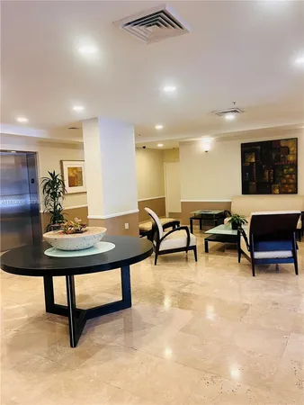 a living room with furniture a flat screen tv and a table