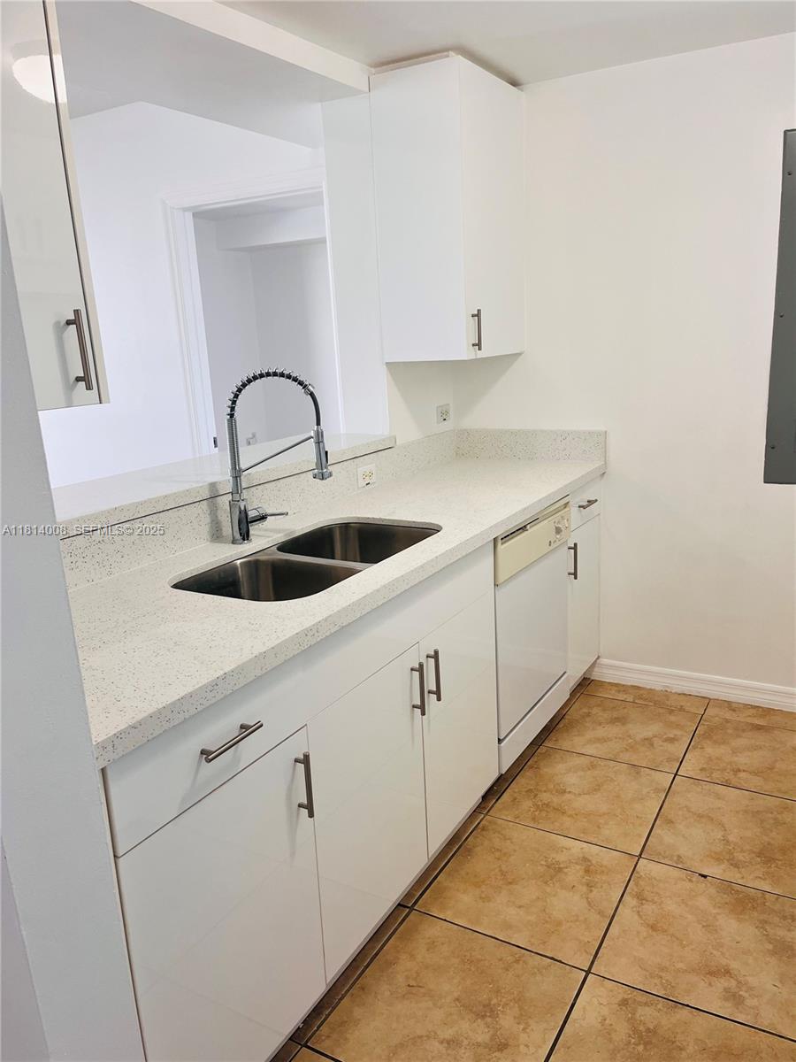 900 Southwest 8th Street, Unit 806 Miami, FL 33130 - Photo 18 of 22 a kitchen with white cabinets and sink