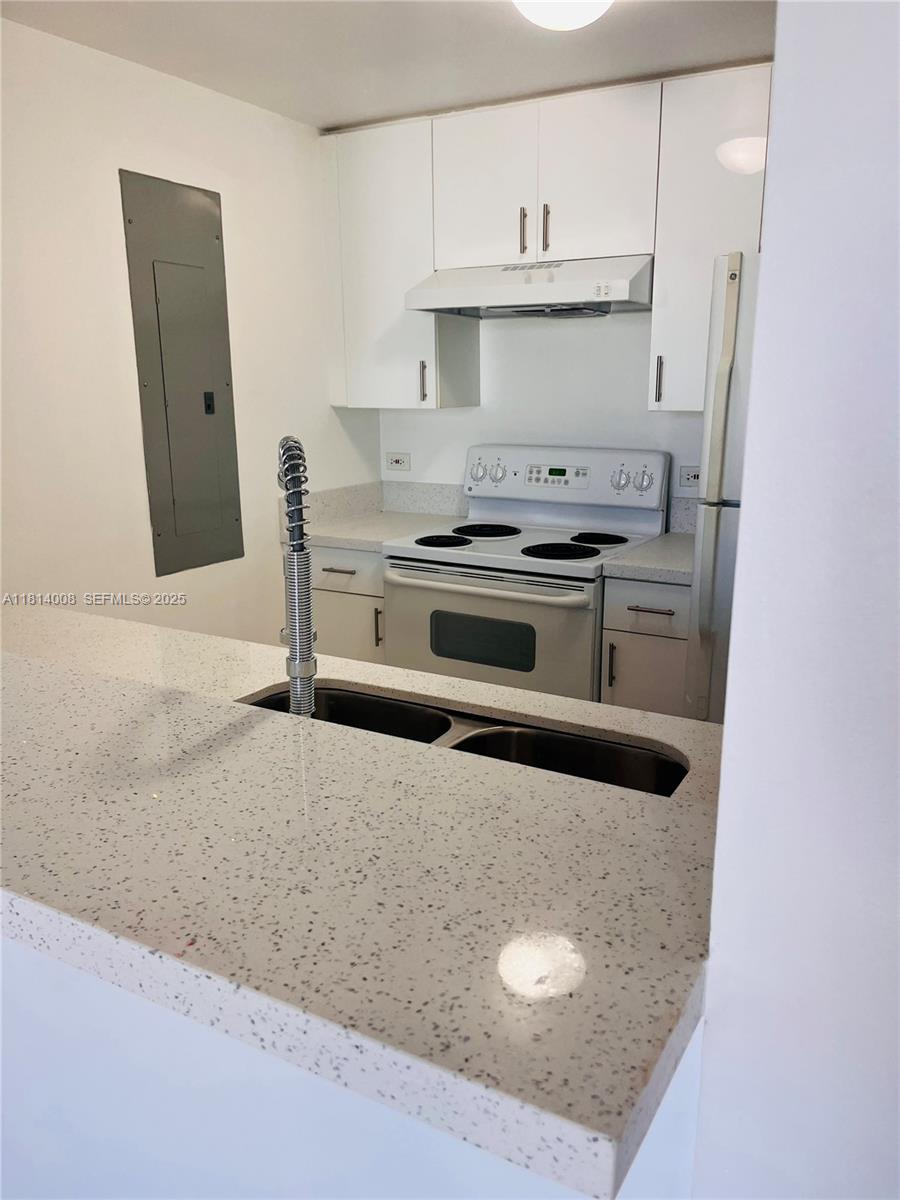 900 Southwest 8th Street, Unit 806 Miami, FL 33130 - Photo 20 of 22 a kitchen with stainless steel appliances granite countertop a stove and a refrigerator