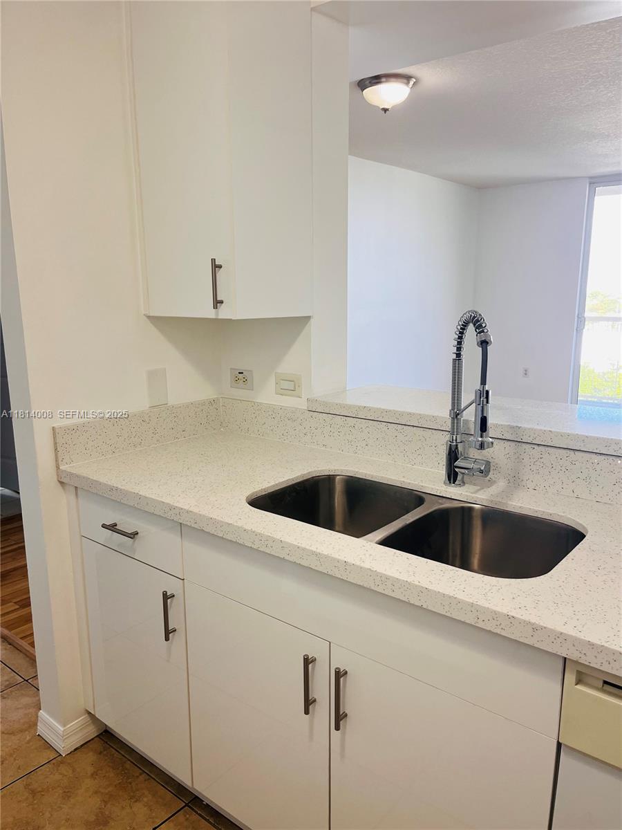 900 Southwest 8th Street, Unit 806 Miami, FL 33130 - Photo 21 of 22 a close view of a sink and dishwasher with kitchen island