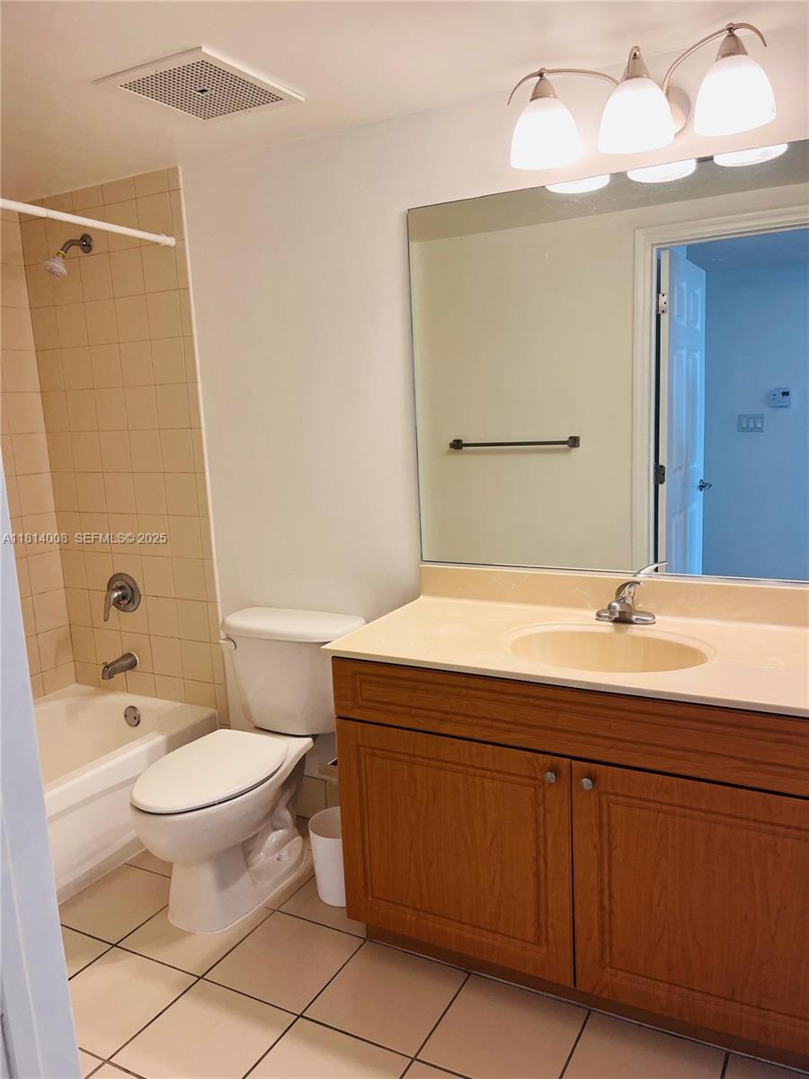 900 Southwest 8th Street, Unit 806 Miami, FL 33130 - Photo 6 of 22 a bathroom with a sink a toilet and shower