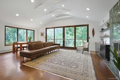 a living room with furniture and a floor to ceiling window