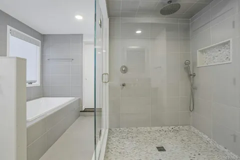 a bathroom with a shower and a bath tub