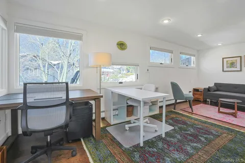 a workspace with furniture and a large window