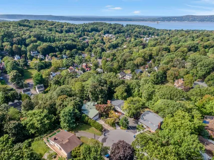 an aerial view of a house with a yard