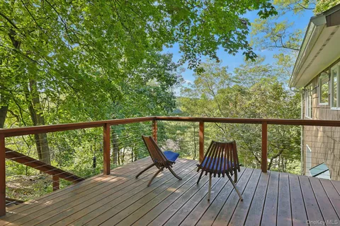 a view of balcony with wooden floor and outdoor seating