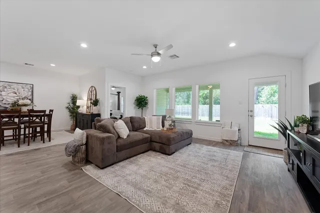 a living room with furniture and wooden floor