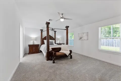 a bedroom with furniture and a window