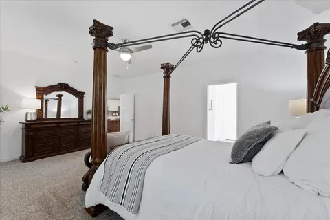 a bedroom with a bed and a dresser