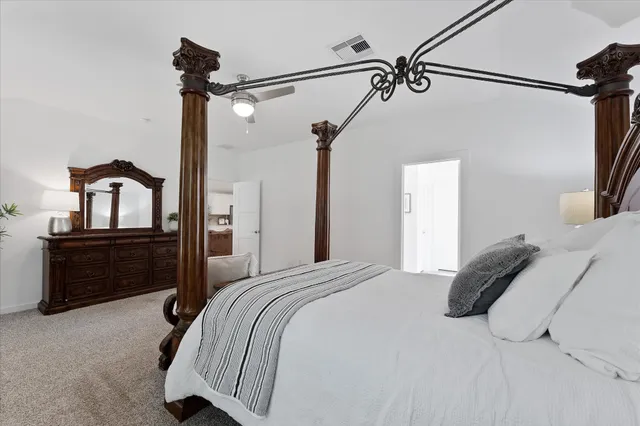 a bedroom with a bed and a dresser