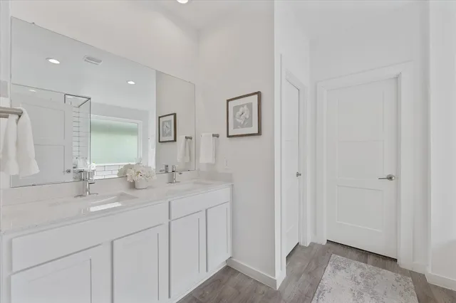 a bathroom with 2 sink and a mirror