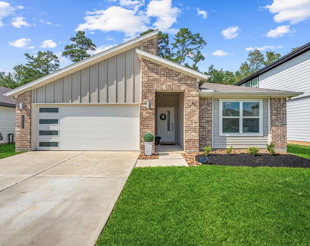 10426 Plateau Pt Trail Conroe, TX 77384 - Photo 2 of 50 a backyard of a house with table and chairs
