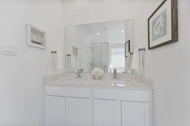 a bathroom with double sink and a mirror