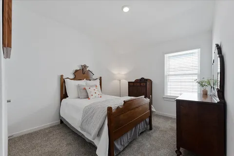 a bedroom with a bed and a desk